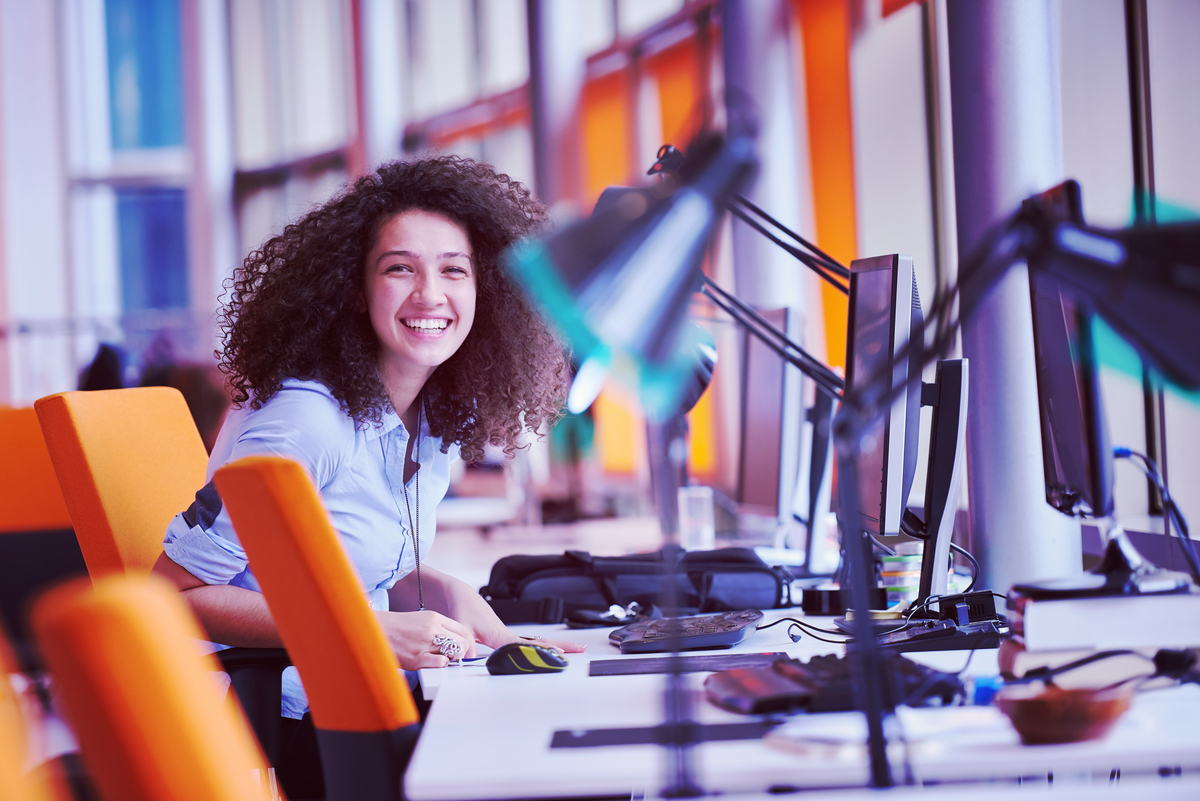 happy young  business woman with curly hairstyle in the modern office