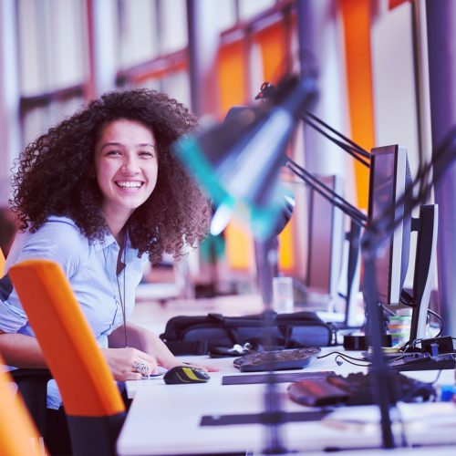 happy young  business woman with curly hairstyle in the modern office